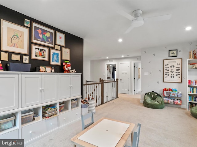 playroom featuring light carpet and ceiling fan