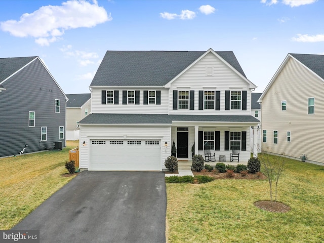 view of front property featuring central AC, a garage, covered porch, and a front lawn