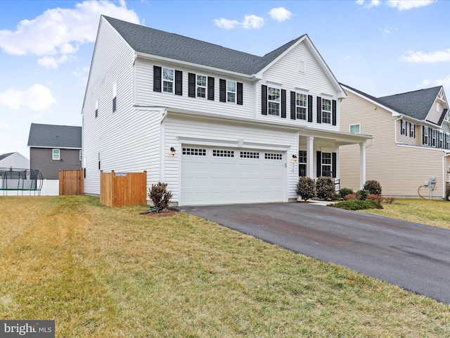 view of front property featuring a garage and a front yard