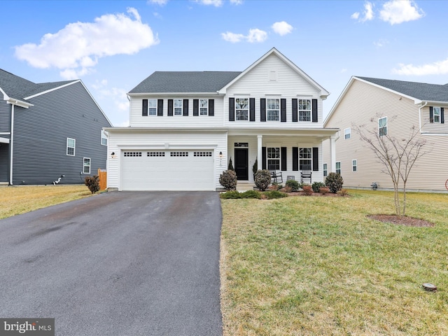 view of front property with a garage, a front yard, and covered porch