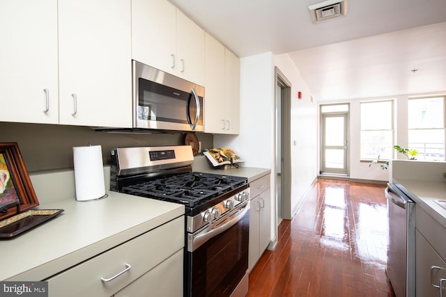 kitchen featuring white cabinetry, stainless steel appliances, and dark hardwood / wood-style flooring