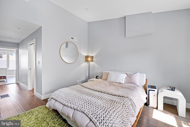 bedroom with dark wood-type flooring