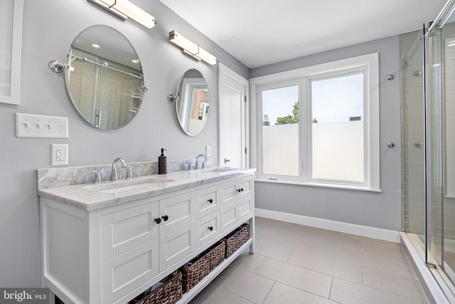 bathroom with tile patterned floors, vanity, and an enclosed shower