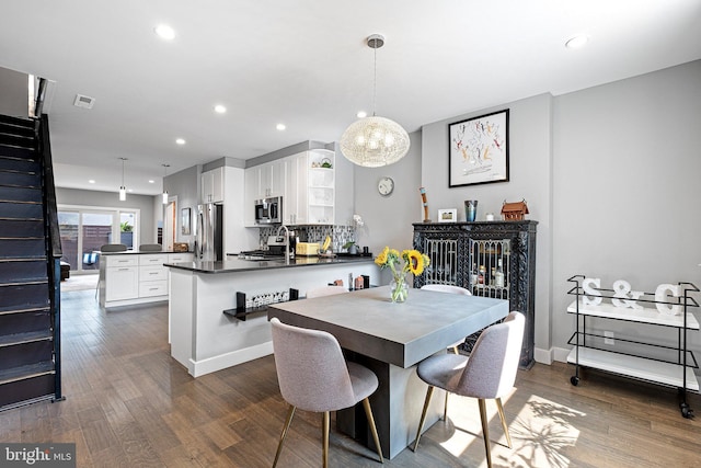 dining space featuring dark wood-type flooring