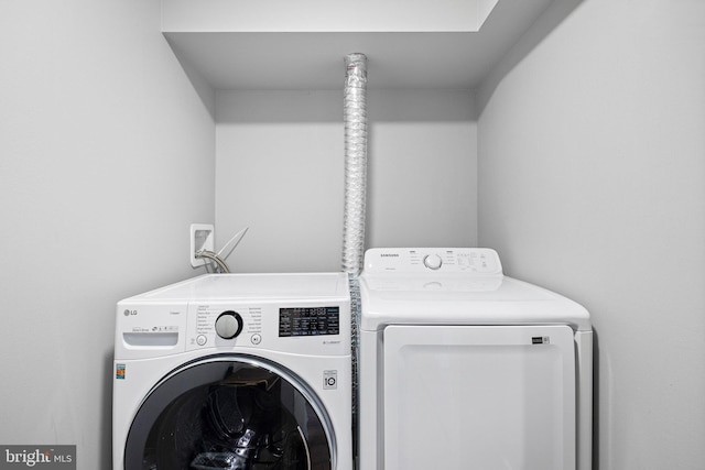 clothes washing area featuring separate washer and dryer