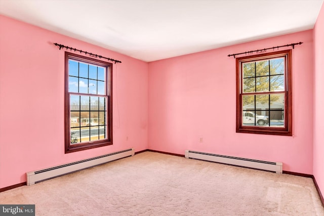 carpeted spare room with plenty of natural light and baseboard heating