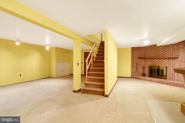 basement featuring a brick fireplace