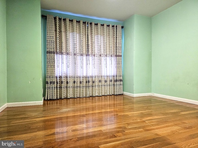 spare room with hardwood / wood-style flooring