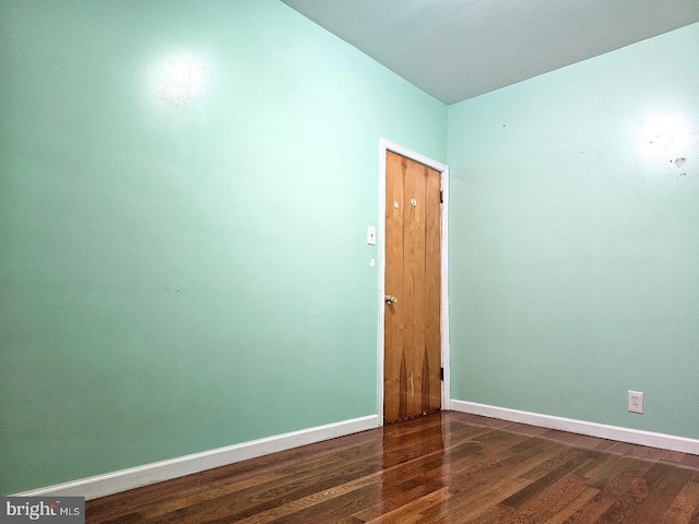 empty room featuring dark wood-type flooring