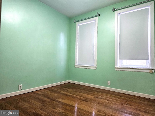 spare room featuring dark hardwood / wood-style flooring