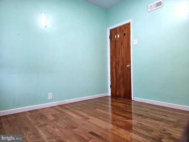 empty room featuring dark wood-type flooring