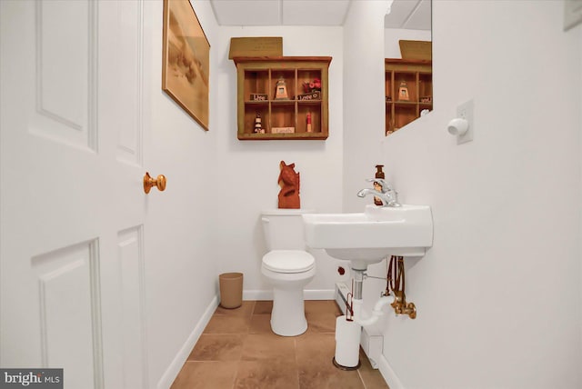 bathroom featuring tile patterned flooring, sink, and toilet