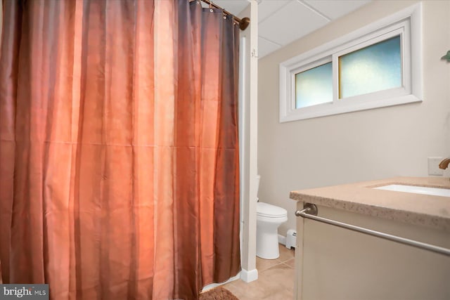 bathroom featuring vanity, a baseboard heating unit, tile patterned floors, and toilet