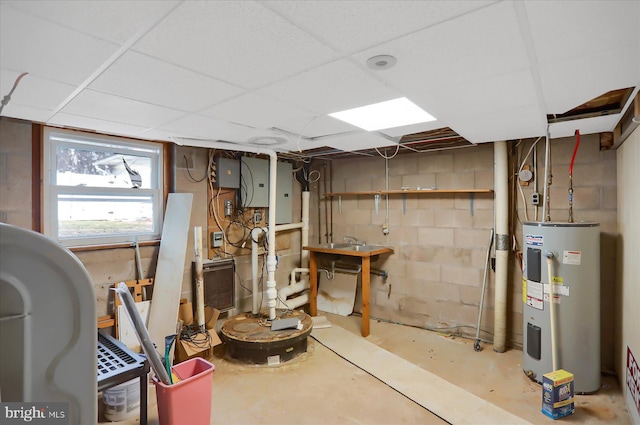 basement featuring a drop ceiling and water heater