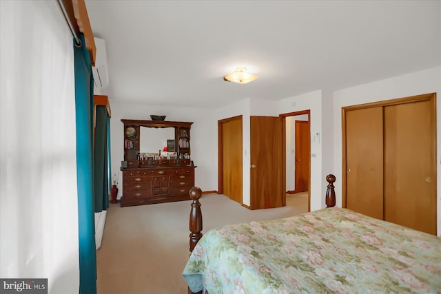 carpeted bedroom featuring a wall mounted air conditioner and a closet