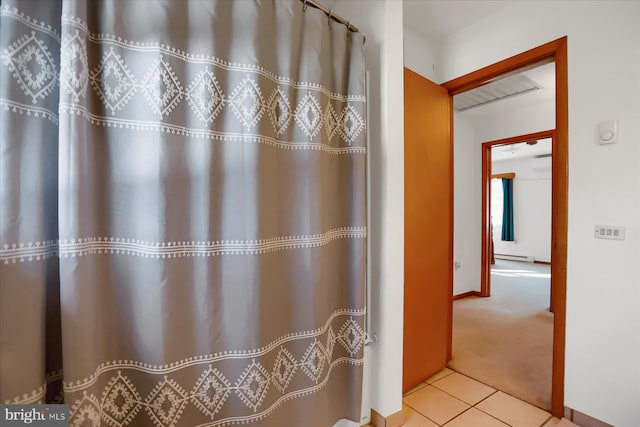 bathroom featuring tile patterned flooring and a baseboard radiator