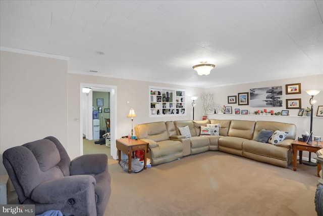 carpeted living room featuring ornamental molding