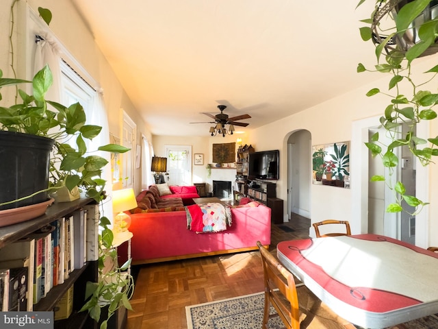 dining space featuring dark parquet floors and ceiling fan