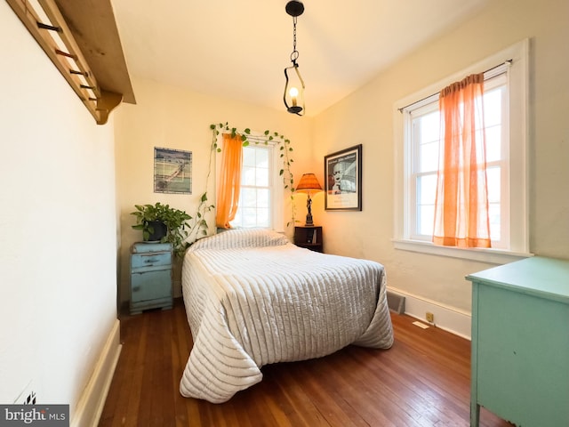 bedroom with dark hardwood / wood-style flooring