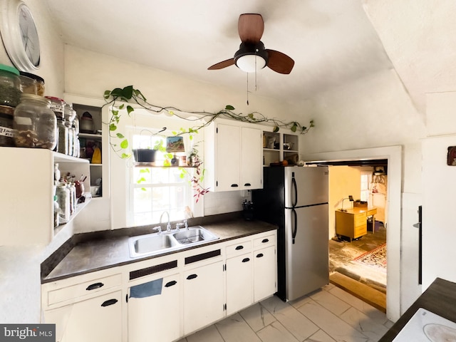 kitchen featuring white cabinetry, sink, stainless steel fridge, and ceiling fan