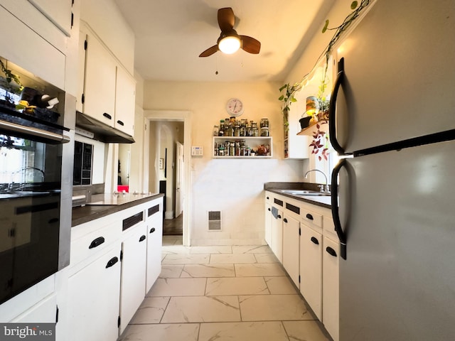 kitchen featuring white cabinetry, sink, stainless steel appliances, and ceiling fan