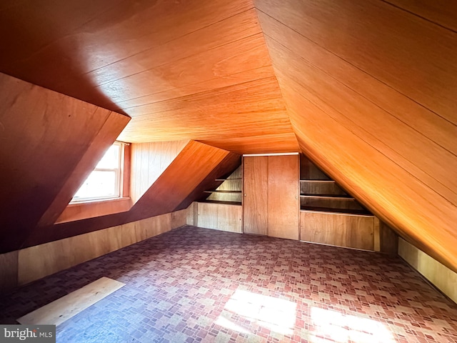 bonus room featuring wooden walls, wooden ceiling, and vaulted ceiling