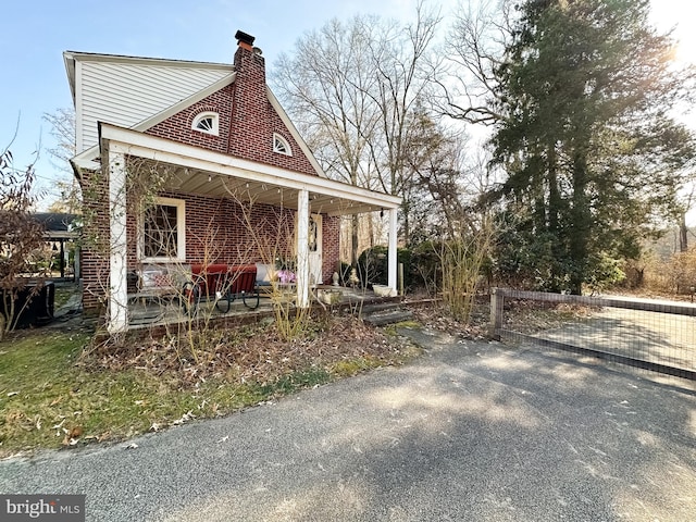 view of side of property with a porch