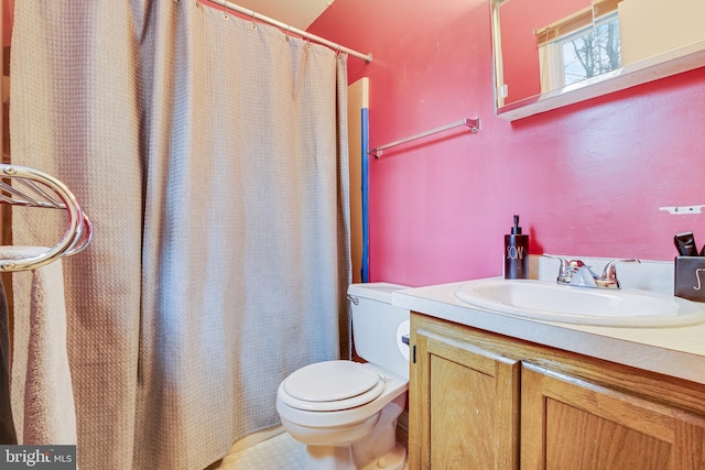 bathroom featuring vanity, toilet, and a shower with shower curtain