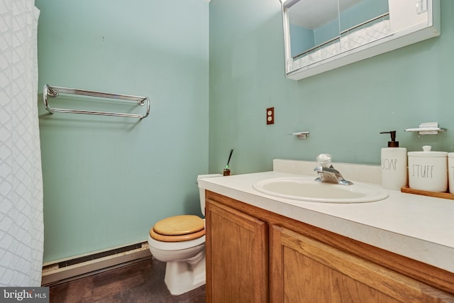 bathroom with vanity, a baseboard heating unit, and toilet