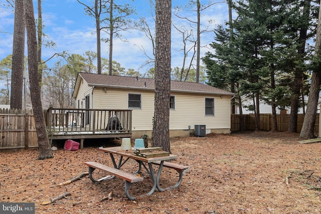 rear view of property with central air condition unit and a deck