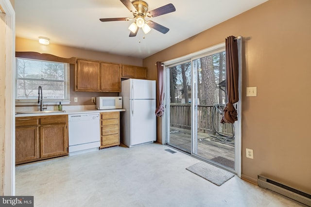 kitchen featuring a baseboard radiator, sink, ceiling fan, and white appliances