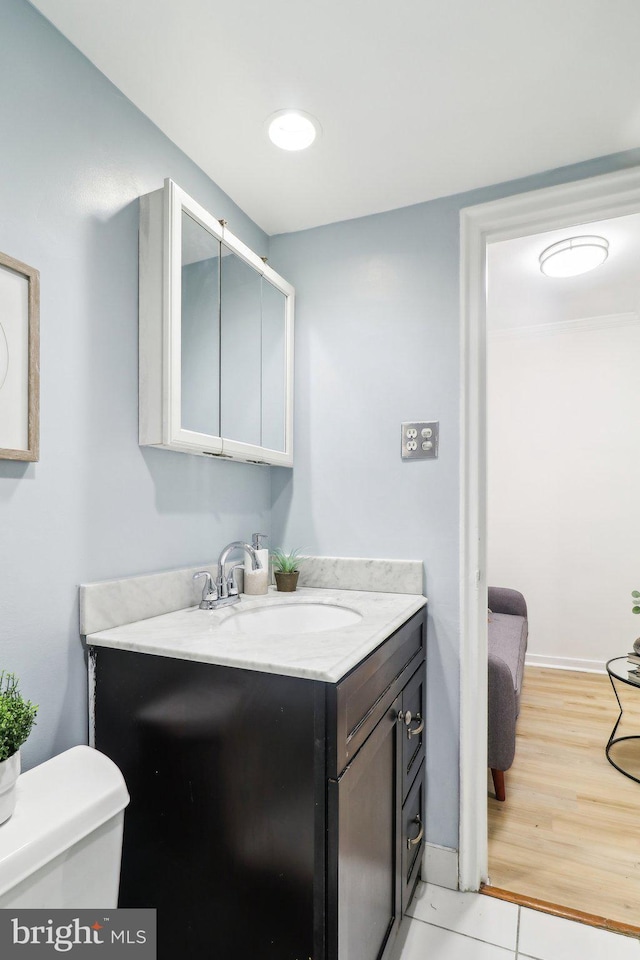 bathroom featuring vanity, toilet, and wood-type flooring