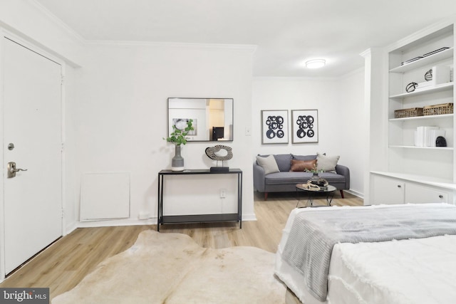 bedroom with ornamental molding and light wood-type flooring