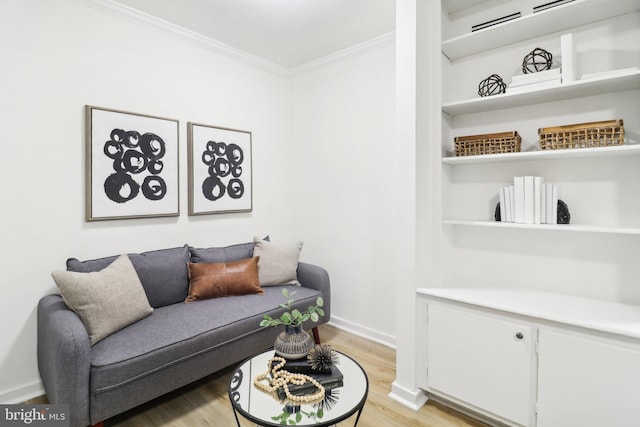 living room featuring crown molding and light wood-type flooring