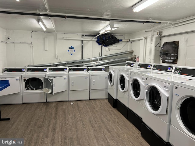 laundry room with dark hardwood / wood-style flooring and washer and dryer