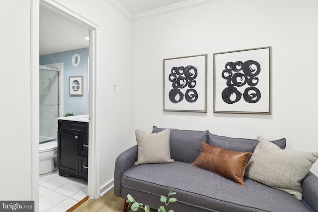 living room with ornamental molding and light hardwood / wood-style flooring