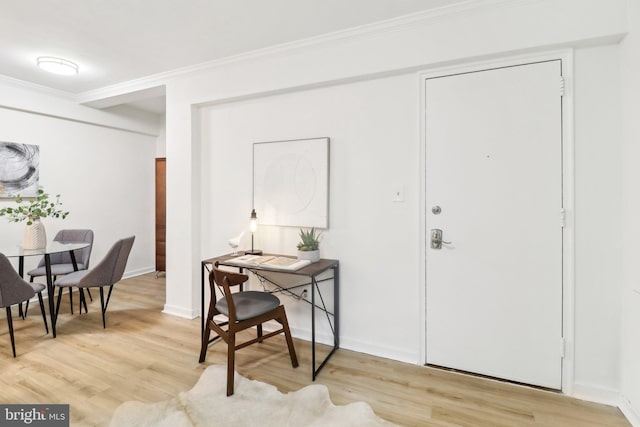 foyer entrance featuring light hardwood / wood-style flooring and ornamental molding