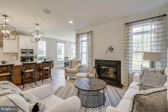 living room featuring sink and light hardwood / wood-style floors