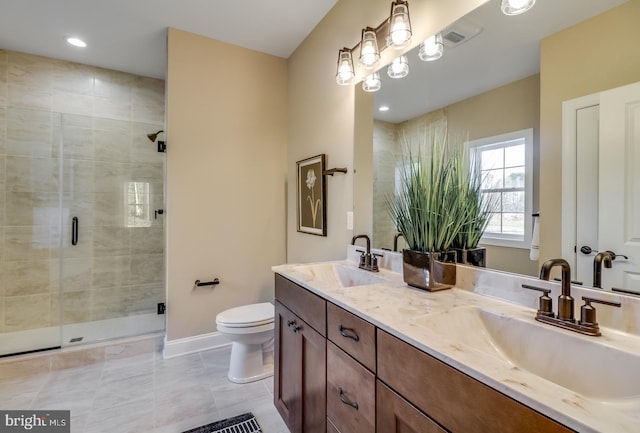 bathroom with vanity, a shower with shower door, tile patterned floors, and toilet