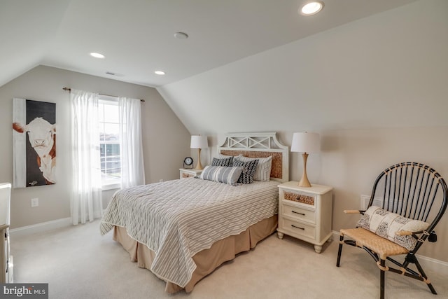 bedroom featuring light colored carpet and vaulted ceiling