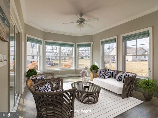 sunroom / solarium featuring ceiling fan