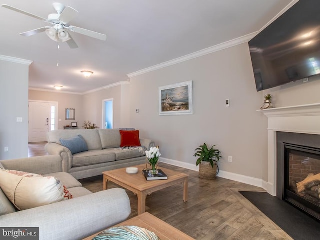 living room featuring crown molding, ceiling fan, and hardwood / wood-style flooring