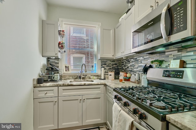 kitchen with sink, stainless steel appliances, and white cabinets