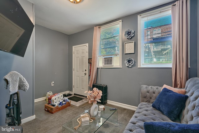 living area featuring cooling unit, radiator heating unit, and carpet