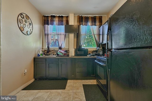 kitchen featuring light tile patterned floors and black appliances