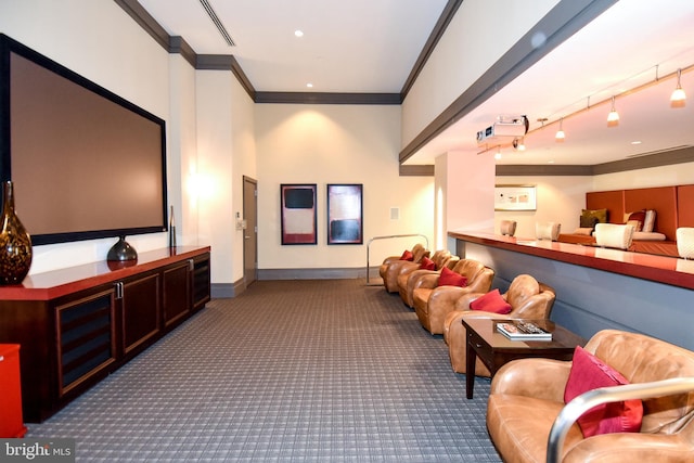 interior space with crown molding, rail lighting, and carpet flooring