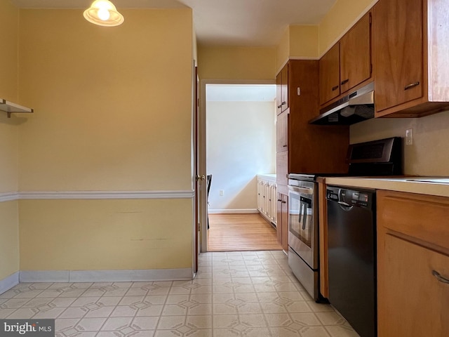 kitchen featuring black dishwasher, baseboards, brown cabinetry, stove, and under cabinet range hood