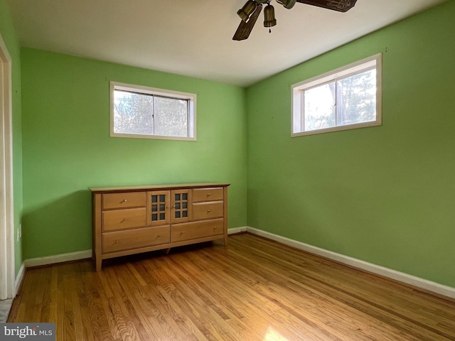 unfurnished bedroom featuring ceiling fan, wood finished floors, and baseboards