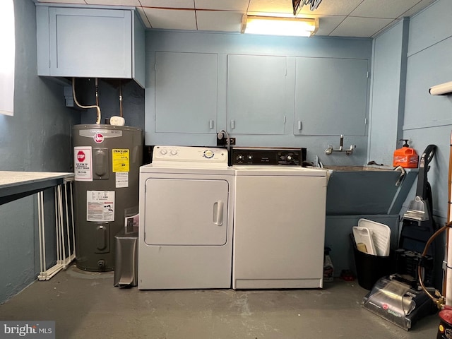 laundry area with water heater, separate washer and dryer, and cabinet space