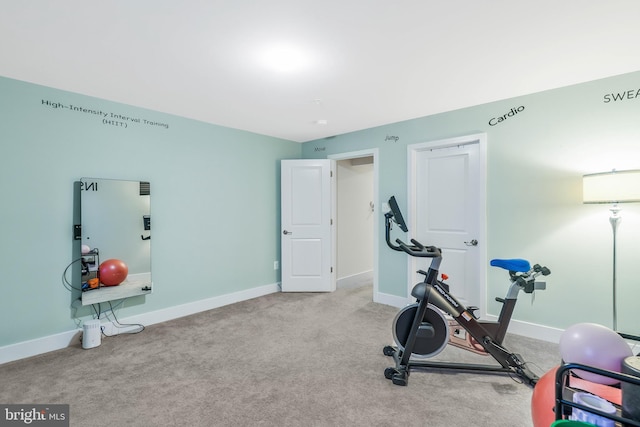 exercise room featuring light colored carpet